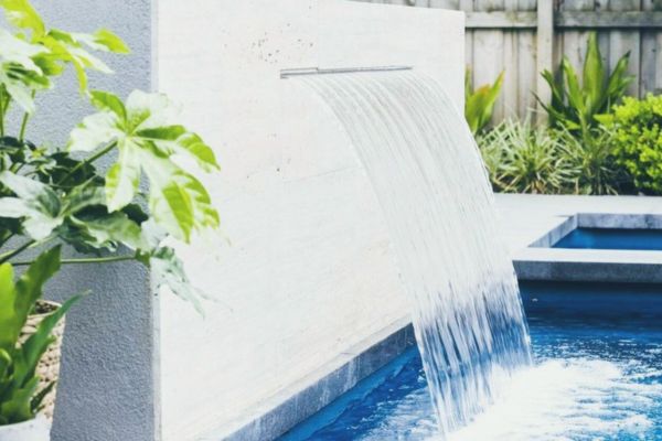 water fountain in concrete pool - cement pool -with water fountain - fountain in pool -swimming pool - with water fall feature